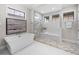 Spa-like bathroom with soaking tub and herringbone tile shower at 11826 River Shores Trl, Parrish, FL 34219