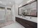 Modern bathroom with double vanity and large mirror at 11826 River Shores Trl, Parrish, FL 34219