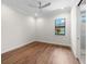 Simple bedroom with hardwood floors and ceiling fan at 11826 River Shores Trl, Parrish, FL 34219