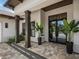 Elegant entryway with dark wood columns and modern glass doors at 11826 River Shores Trl, Parrish, FL 34219