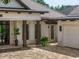 Modern home exterior featuring a covered entryway and paver driveway at 11826 River Shores Trl, Parrish, FL 34219