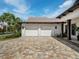 Double car garage with paver driveway and landscaping at 11826 River Shores Trl, Parrish, FL 34219