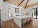Modern kitchen with white cabinets, large island, and hardwood floors at 11826 River Shores Trl, Parrish, FL 34219