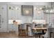 Modern kitchen with breakfast bar, grey barstools and wood flooring at 11826 River Shores Trl, Parrish, FL 34219