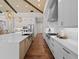 Open concept kitchen with island, high-end appliances, and hardwood floors at 11826 River Shores Trl, Parrish, FL 34219