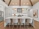 Modern kitchen with white cabinets, a large island and hardwood floors at 11826 River Shores Trl, Parrish, FL 34219