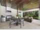 Modern outdoor kitchen and lounge area with wood ceiling at 11826 River Shores Trl, Parrish, FL 34219