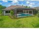 Luxury screened pool and patio area with lush landscaping at 11826 River Shores Trl, Parrish, FL 34219