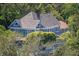 Two-story home with lush surrounding foliage, showcasing privacy and a tranquil setting at 304 15Th W St, Bradenton, FL 34205