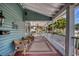 Inviting porch featuring wicker seating, area rugs, and overhead fans providing comfort and style at 304 15Th W St, Bradenton, FL 34205