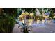 Inviting front porch with decorative hanging plants and ample lighting, perfect for relaxing outdoors at 304 15Th W St, Bradenton, FL 34205
