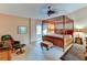 Spacious bedroom with canopy bed and access to a patio at 6016 Courtside Dr # 111, Bradenton, FL 34210