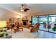 Living room with fireplace, comfy seating, and access to sunroom at 6016 Courtside Dr # 111, Bradenton, FL 34210