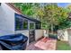 Private patio with grill and lush landscaping at 6016 Courtside Dr # 111, Bradenton, FL 34210