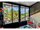 Sunroom with wicker chairs and view of tropical landscape at 6016 Courtside Dr # 111, Bradenton, FL 34210