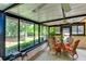 Bright sunroom with wicker furniture and view of the backyard at 6016 Courtside Dr # 111, Bradenton, FL 34210
