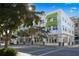 Modern building with green awnings and street-level retail space at 430 Kumquat Ct # 310, Sarasota, FL 34236