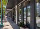 Storefronts with gray doors and windows along a sidewalk at 430 Kumquat Ct # 310, Sarasota, FL 34236