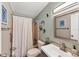 Charming bathroom with white shower curtain and decorative accents at 1532 46Th Avenue E Dr, Ellenton, FL 34222