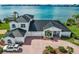 Luxury waterfront home with a metal roof and expansive water views at 443 Picasso Dr, Nokomis, FL 34275