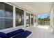 Covered balcony offering water views and comfortable seating at 443 Picasso Dr, Nokomis, FL 34275