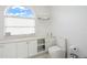 Clean bathroom with a toilet, vanity, and large window at 443 Picasso Dr, Nokomis, FL 34275