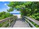 Wooden boardwalk leads to a beautiful sandy beach at 443 Picasso Dr, Nokomis, FL 34275