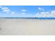 Beachfront property with umbrellas and people enjoying a sunny day at 443 Picasso Dr, Nokomis, FL 34275