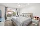 Cozy bedroom with a queen-size bed and crib at 443 Picasso Dr, Nokomis, FL 34275