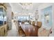 Elegant dining room with a large table and chandelier at 443 Picasso Dr, Nokomis, FL 34275