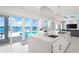 Modern kitchen with white cabinets, island, and stainless steel appliances at 443 Picasso Dr, Nokomis, FL 34275