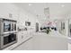 Spacious kitchen boasts stainless steel appliances and white cabinetry at 443 Picasso Dr, Nokomis, FL 34275