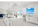 Bright kitchen featuring white cabinetry, quartz countertops, and water views at 443 Picasso Dr, Nokomis, FL 34275