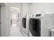Bright laundry room with modern washer and dryer at 443 Picasso Dr, Nokomis, FL 34275