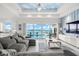 Bright living room with water views and a large sectional at 443 Picasso Dr, Nokomis, FL 34275
