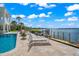 Serene poolside with lounge chairs and waterfront access at 443 Picasso Dr, Nokomis, FL 34275