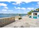Stunning waterfront view with stone staircase and balustrade at 443 Picasso Dr, Nokomis, FL 34275