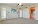 Bedroom featuring neutral carpeting and walls, ceiling fan, and access to a private bathroom and balcony at 4410 Fairways Blvd # 505, Bradenton, FL 34209