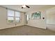 Bedroom featuring neutral carpeting and walls, ceiling fan, and access to balcony at 4410 Fairways Blvd # 505, Bradenton, FL 34209