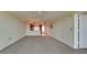 Open-concept living room with a view of the kitchen and entrance, enhanced by neutral walls and carpeting at 4410 Fairways Blvd # 505, Bradenton, FL 34209