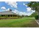 Community clubhouse with manicured lawn and landscaping at 2909 Old Orchard Ln, Parrish, FL 34219
