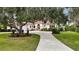 Beautiful Spanish style home with lush landscaping and a long driveway at 2909 Old Orchard Ln, Parrish, FL 34219
