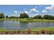 Serene golf course with water feature and landscaping at 2909 Old Orchard Ln, Parrish, FL 34219