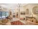 Spacious living room featuring a fireplace and access to the backyard at 2909 Old Orchard Ln, Parrish, FL 34219