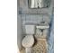 Small bathroom with toilet, sink, and nautical-themed walls at 3710 Gulf Of Mexico Dr # E3, Longboat Key, FL 34228