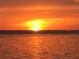 Spectacular sunset over calm ocean water at 3710 Gulf Of Mexico Dr # E3, Longboat Key, FL 34228