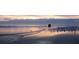 Couple walking on the beach at sunrise at 1305 4Th St # 401G, Sarasota, FL 34236