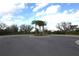 Landscaped entrance with palm trees and circular driveway at 11936 Sky Acres Ter, Bradenton, FL 34211