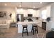 Modern kitchen with white cabinets, island seating, and stainless steel appliances at 11936 Sky Acres Ter, Bradenton, FL 34211