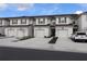 Row of three-story townhouses with attached garages at 11936 Sky Acres Ter, Bradenton, FL 34211